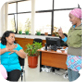 Women communicating through sign language at their work place.